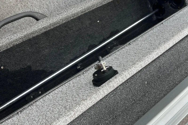 Slide: The Image of 2023 Alumacraft Voyageur 175 SC interior detail, featuring storage compartment and handle. - 27