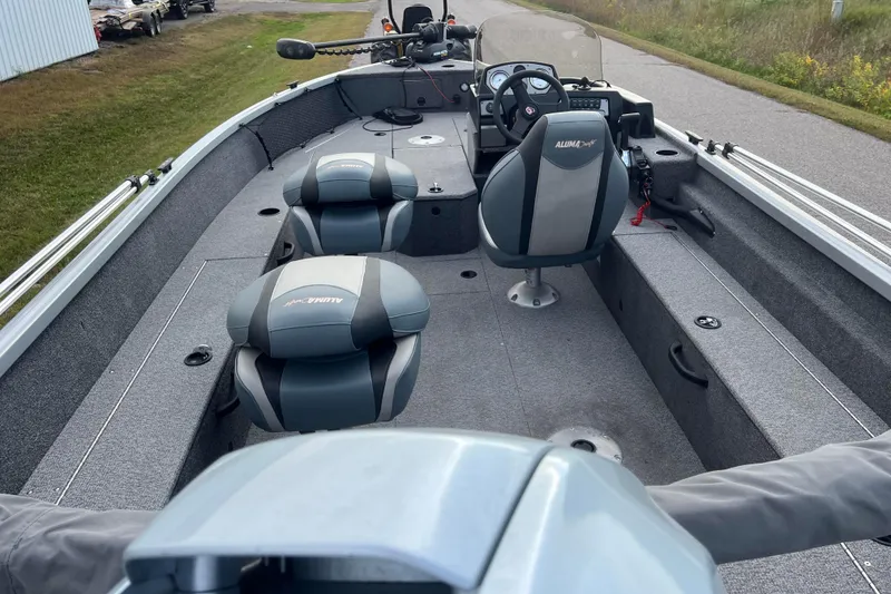 Slide: The Image of 2023 Alumacraft Voyageur 175 SC boat interior with seating and steering console. - 3