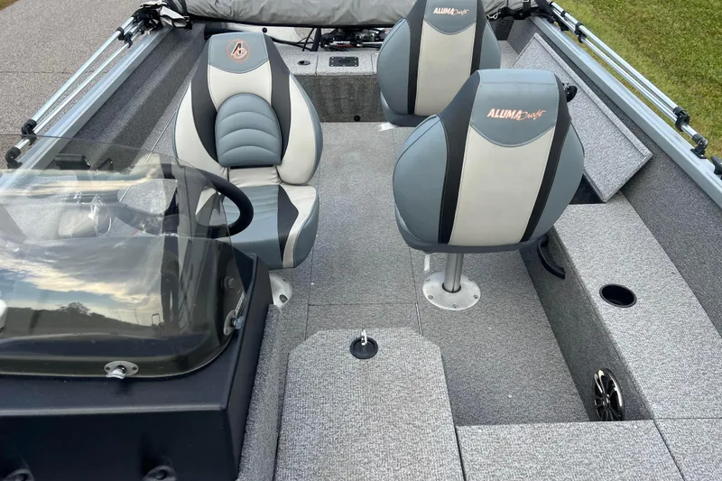 Slide: The Image of 2023 Alumacraft Voyageur 175 SC boat interior with seating and steering console. - 37
