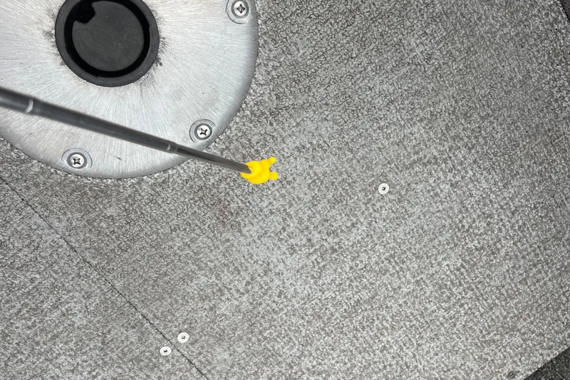Slide: The Image of Close-up of Alumacraft Voyageur 175 SC 2023 boat floor with a yellow-handled tool. - 38