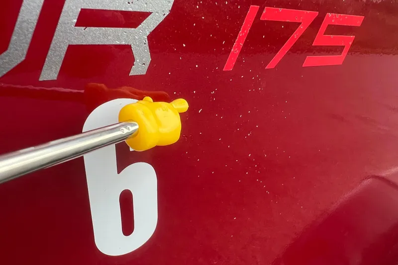 Slide: The Image of Close-up of 2023 Alumacraft Voyageur 175 SC boat with yellow tool on red surface. - 42