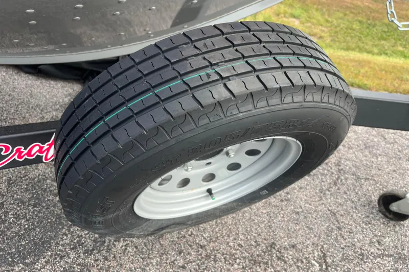Slide: The Image of 2023 Alumacraft Voyageur 175 SC trailer tire on asphalt, showcasing tread pattern. - 45