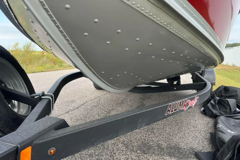 Slide: The Image of 2023 Alumacraft Voyageur 175 SC boat on trailer, close-up view of hull and logo. - 48