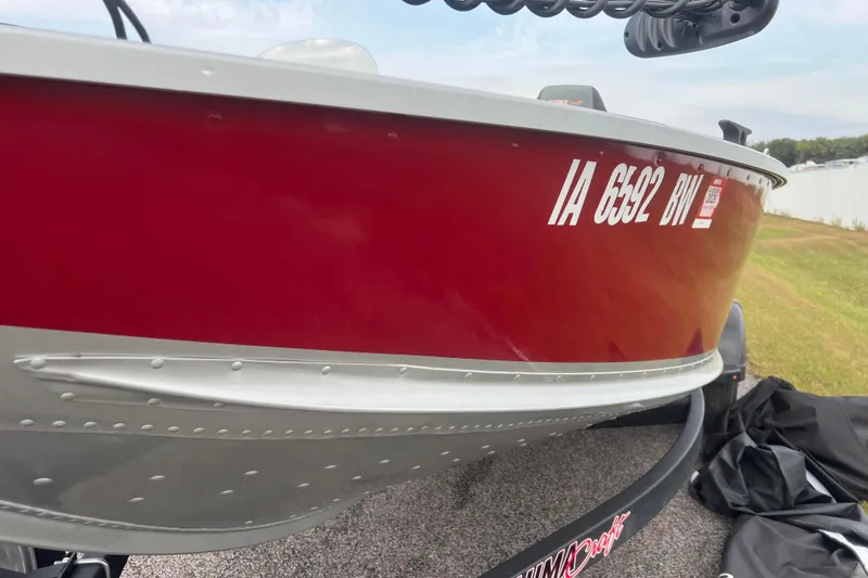 Slide: The Image of 2023 Alumacraft Voyageur 175 SC boat with red exterior and registration number IA 6592 BW. - 49