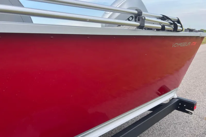 Slide: The Image of 2023 Alumacraft Voyageur 175 SC boat with red exterior on a trailer. - 52