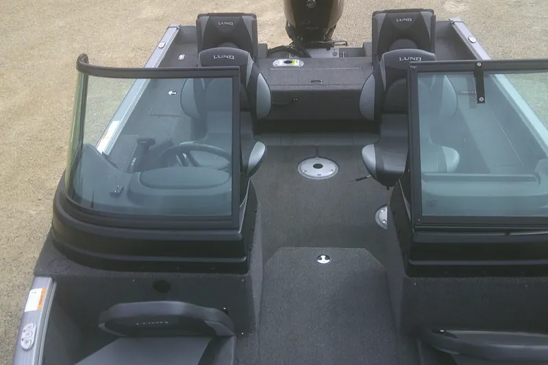 Slide: The Image of 2022 Lund 1675 Impact XS Sport boat interior with seating and windshield. - 10