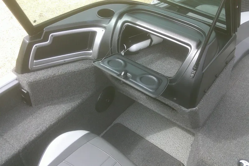 Slide: The Image of 2022 Lund 1675 Impact XS Sport boat interior with open storage compartment. - 12