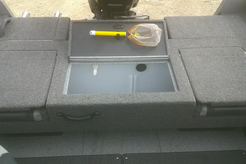 Slide: The Image of 2022 Lund 1675 Impact XS Sport boat interior with storage compartments and fishing net. - 15