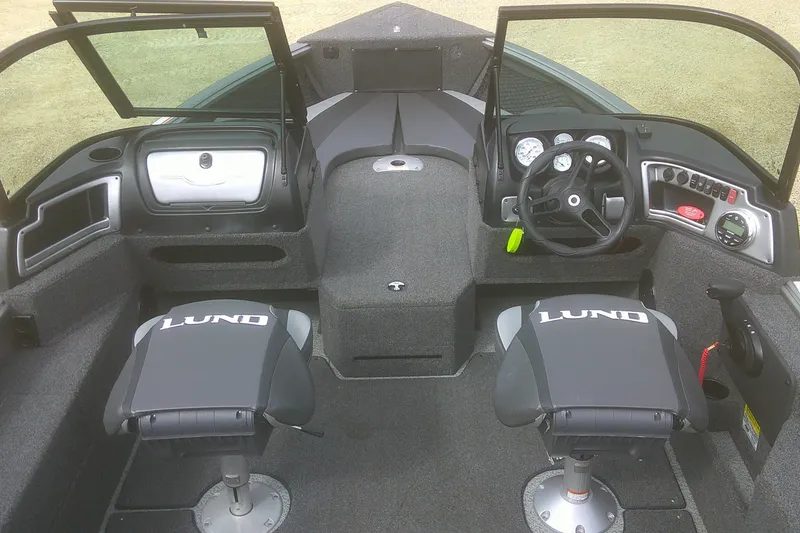 Slide: The Image of 2022 Lund 1675 Impact XS Sport boat interior with dual seats and control panel. - 4