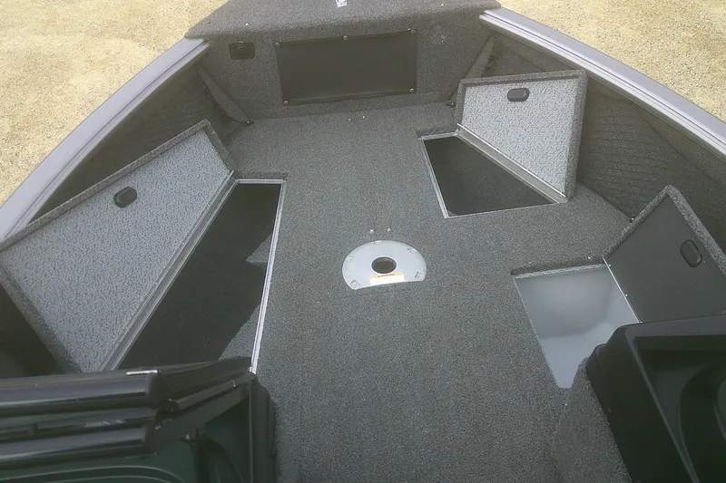 Slide: The Image of 2022 Lund 1675 Impact XS Sport boat interior with open storage compartments. - 5