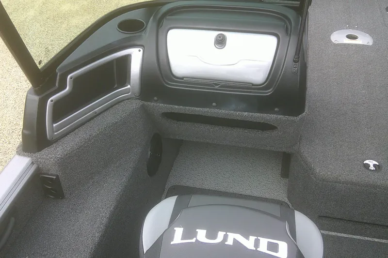 Slide: The Image of 2022 Lund 1675 Impact XS Sport boat interior with storage compartments and seating. - 8