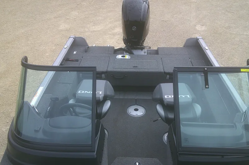 Slide: The Image of 2022 Lund 1675 Impact XS Sport boat interior with seating and windshield. - 9