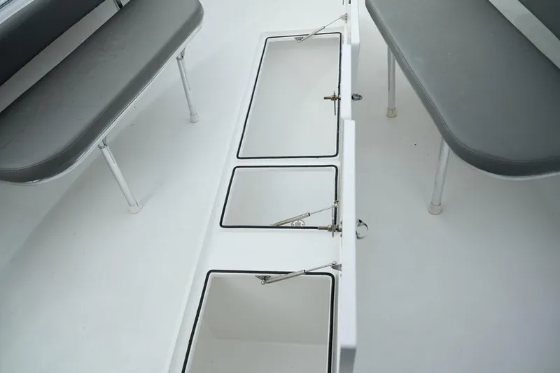 Slide: The Image of 2024 Onslow Bay 33 Tournament boat interior with storage compartments and seating. - 11