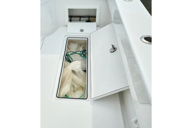 Slide: The Image of 2024 Onslow Bay 33 Tournament boat storage compartment with fishing net. - 7