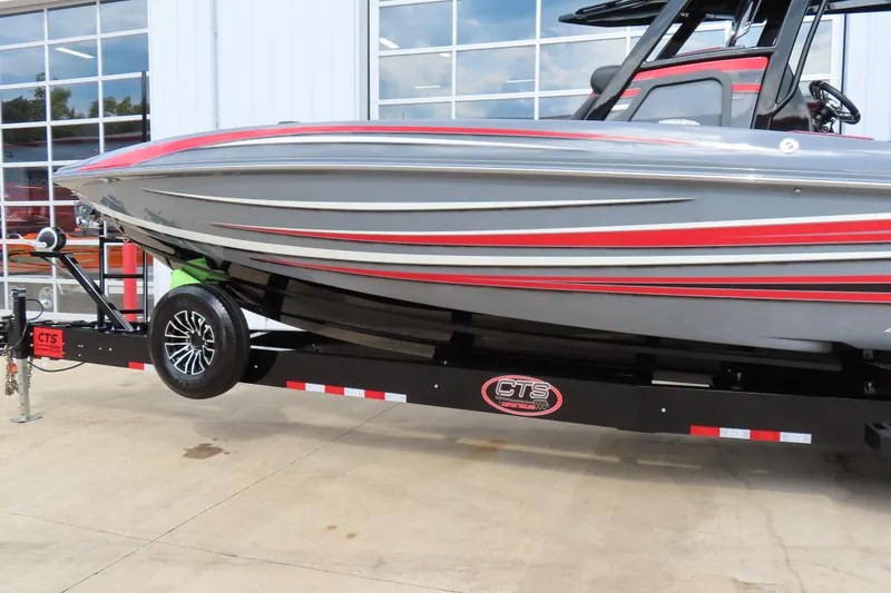 Slide: The Image of 2025 Sunsation 32CCX boat on trailer, sleek gray and red design, parked outdoors. - 3