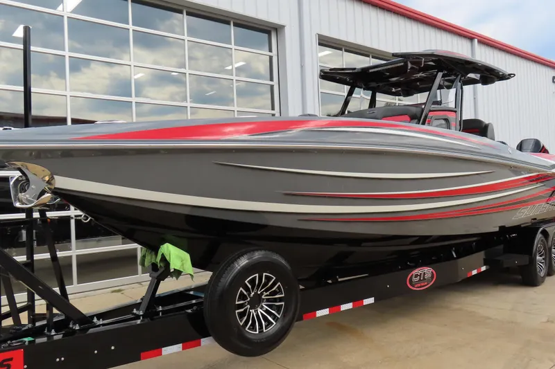 Slide: The Image of 2025 Sunsation 32CCX boat on trailer, sleek design with red and gray accents. - 6