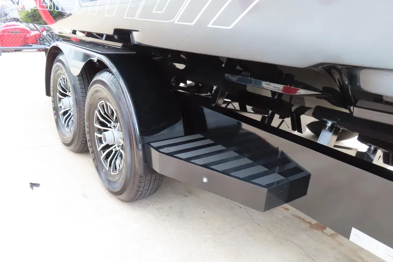 Slide: The Image of 2025 Sunsation 32CCX boat trailer with dual wheels and black step detail. - 9