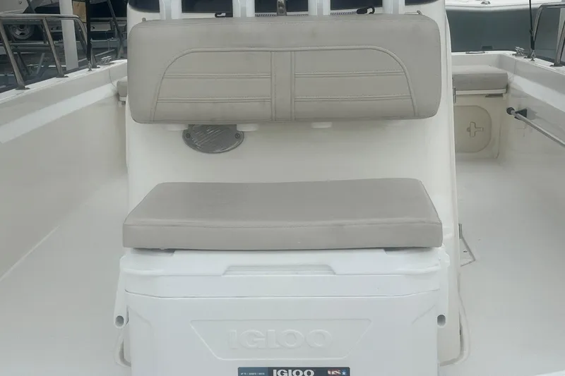 Slide: The Image of 2022 Boston Whaler 170 Montauk boat interior with cushioned seating and Igloo cooler. - 10
