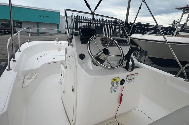 Slide: The Image of 2022 Boston Whaler 170 Montauk boat interior with steering console and seating area. - 13