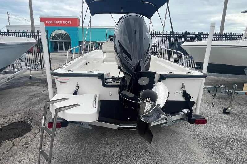 Slide: The Image of 2022 Boston Whaler 170 Montauk boat, rear view with motor and swim ladder. - 6