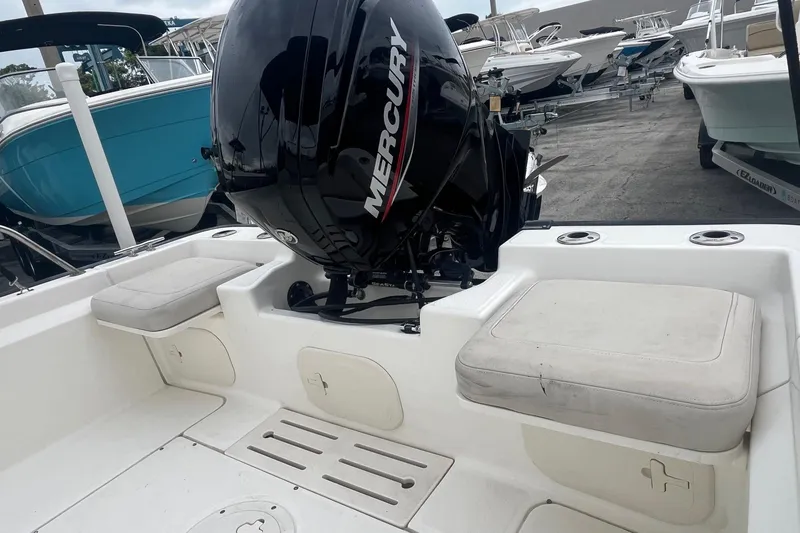 Slide: The Image of 2022 Boston Whaler 170 Montauk boat with Mercury engine, featuring cushioned seating and storage compartments. - 9