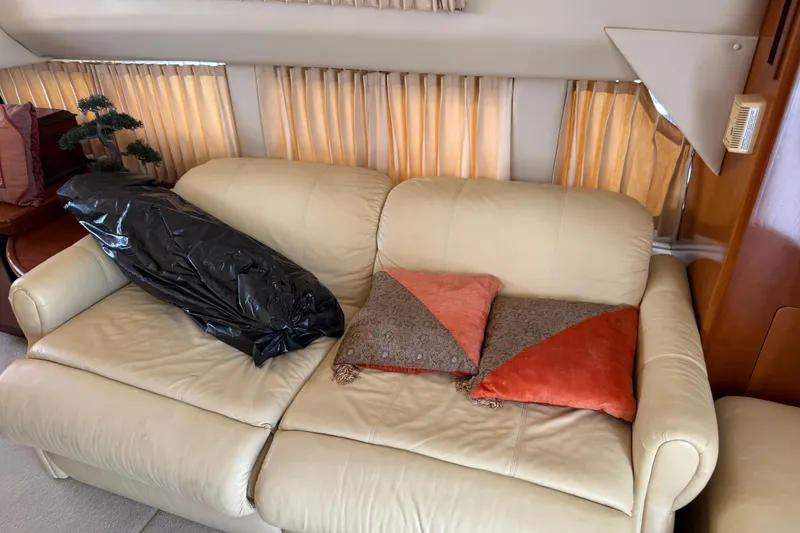 Slide: The Image of Cream leather sofa with decorative pillows inside a 2003 Carver 360 Sport Sedan. - 14