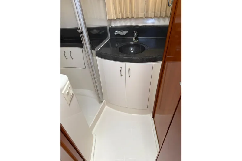 Slide: The Image of 2003 Carver 360 Sport Sedan bathroom with black countertop and sink. - 17