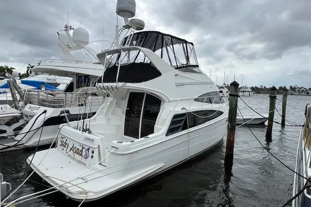 Slide: The Image of 2003 Carver 360 Sport Sedan yacht docked at marina under cloudy skies. - 3