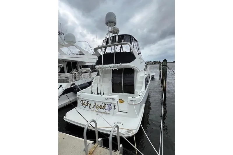 Slide: The Image of 2003 Carver 360 Sport Sedan yacht docked under cloudy skies. - 4