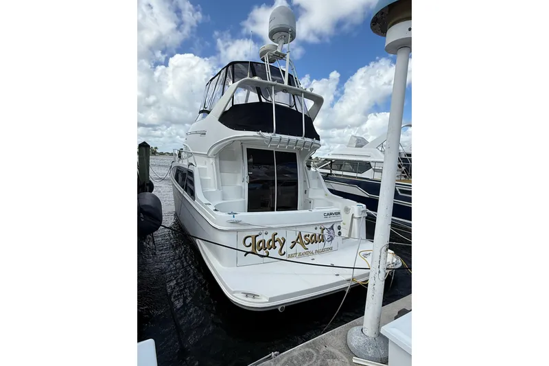 Slide: The Image of 2003 Carver 360 Sport Sedan yacht docked at marina under cloudy sky. - 5