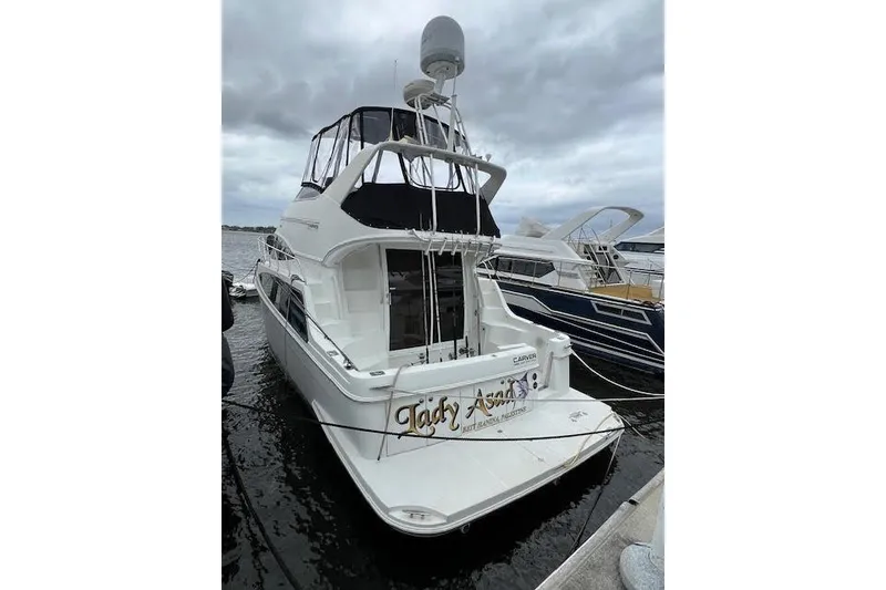 Slide: The Image of 2003 Carver 360 Sport Sedan yacht docked at marina under cloudy sky. - 6