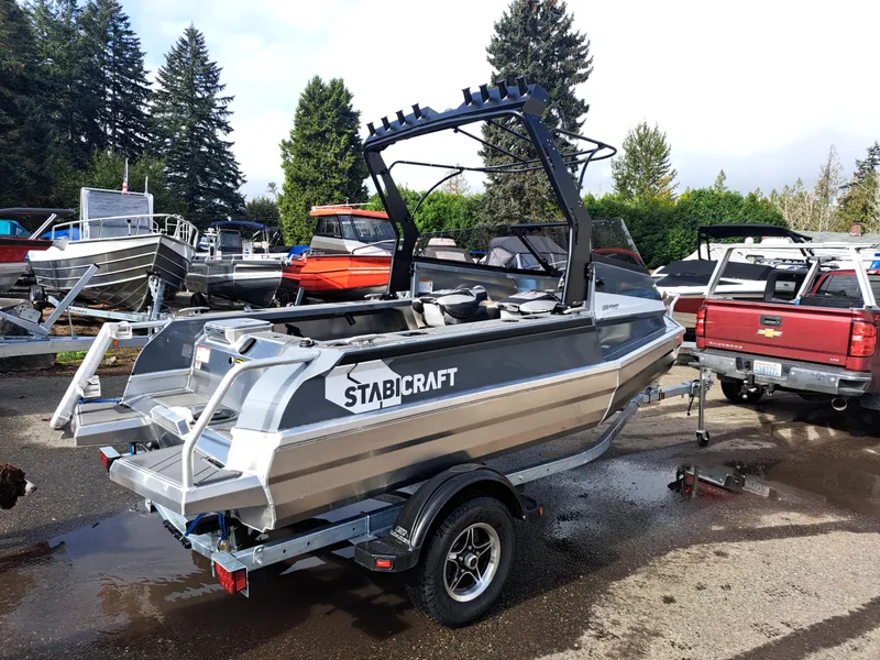 Slide: The Image of 2024 Stabicraft 1550 Fisher boat on trailer, parked outdoors with other boats. - 4