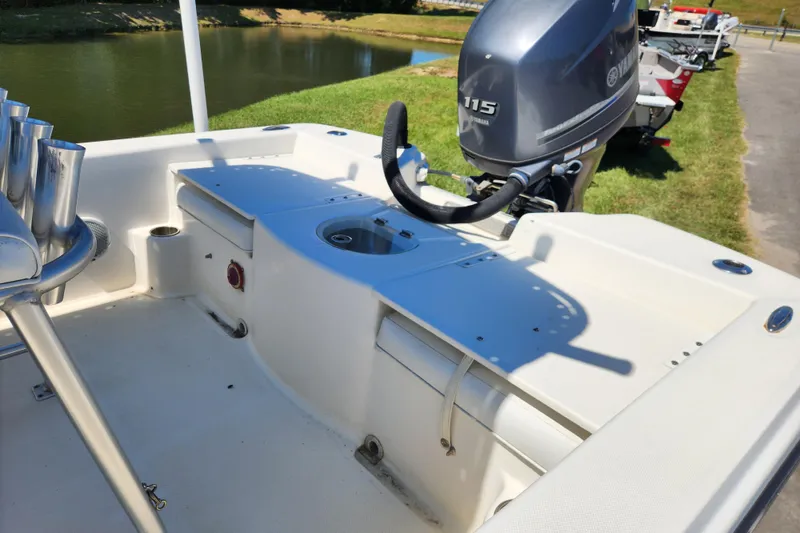 Slide: The Image of 2014 Sundance B22CC boat with Yamaha 115 engine, docked near a pond. - 10