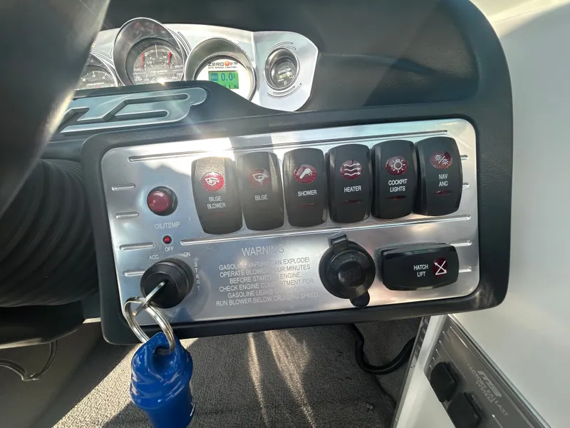 Slide: The Image of Dashboard controls of a 2011 MB SPORTS 21 Tomcat boat with various switches and gauges. - 7