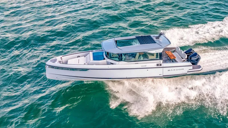 Slide: The Image of 2025 Saxdor 320 GTC cruising on open water. - 1