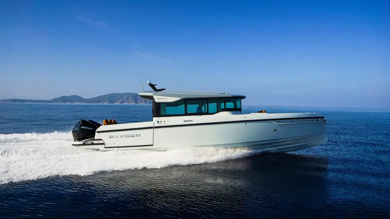 Slide: The Image of 2025 Saxdor 320 GTC cruising on open water with scenic mountain backdrop. - 14