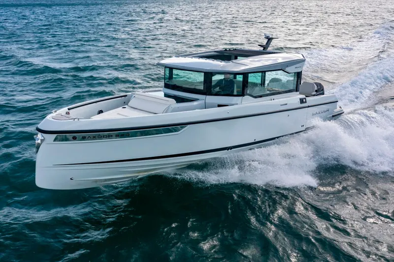 Slide: The Image of 2025 Saxdor 320 GTC boat cruising on the ocean. - 2