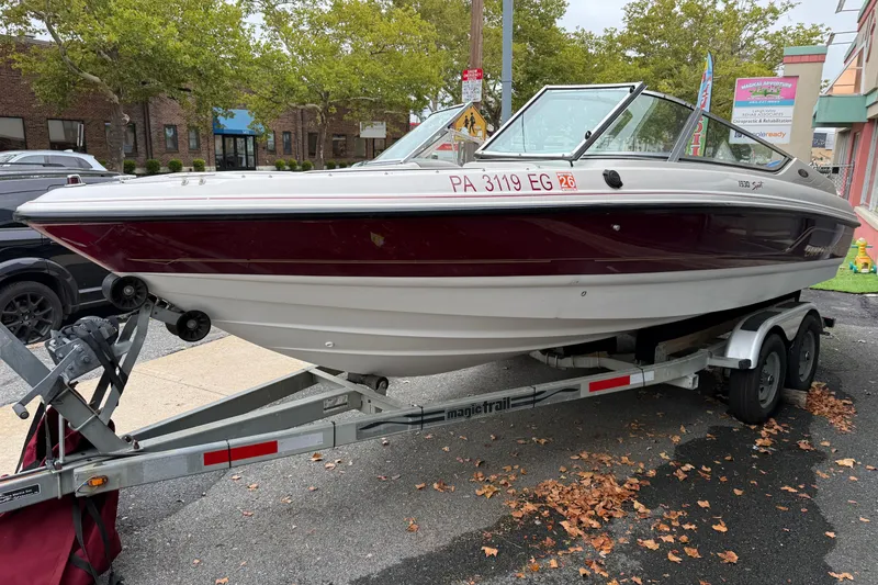 Slide: The Image of Chaparral 1930 SS 1999 boat on trailer, parked outdoors with trees in background. - 3