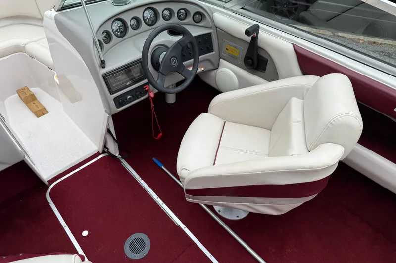 Slide: The Image of Interior of a 1999 Chaparral 1930 SS boat with red carpet and white seating. - 6