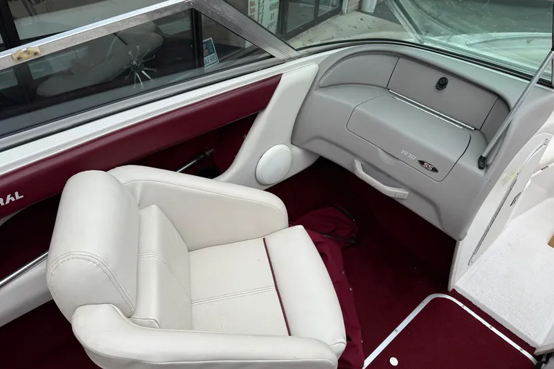 Slide: The Image of Interior of a 1999 Chaparral 1930 SS boat with white seating and maroon accents. - 8