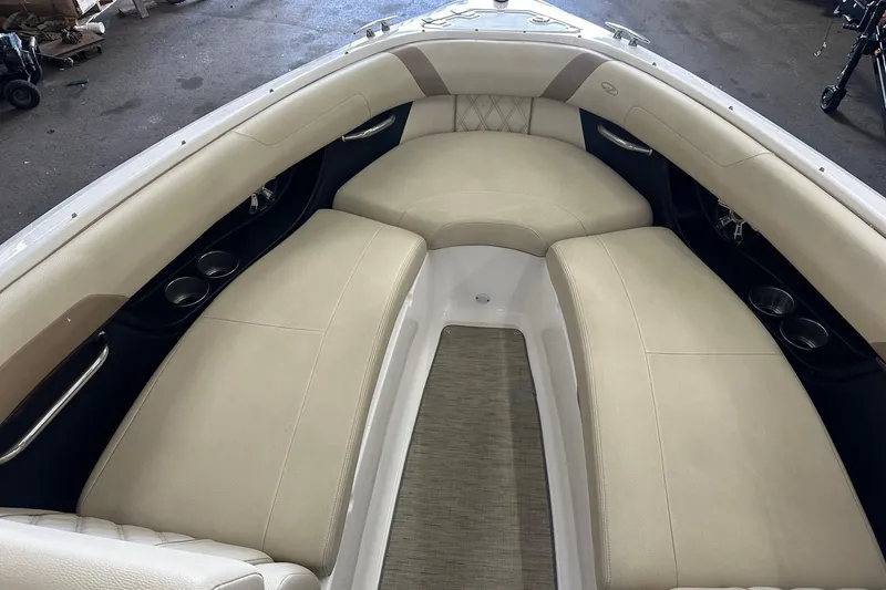 Slide: The Image of 2018 Regal 2500 Bowrider interior with beige seating and cup holders. - 10