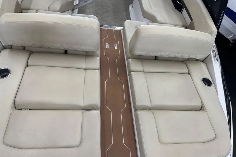 Slide: The Image of Luxurious seating on 2018 Regal 2500 Bowrider boat with beige upholstery and cup holders. - 12