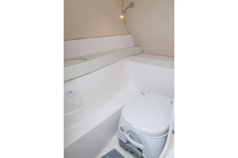 Slide: The Image of Manufacturer Provided Image: 2018 Regal 2500 Bowrider boat interior bathroom with toilet and light. - 18