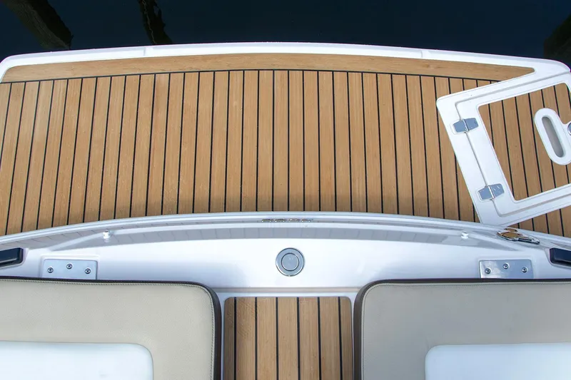 Slide: The Image of 2018 Regal 2500 Bowrider interior with beige seating and wooden table. - 7