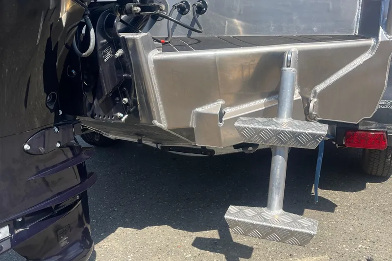 Slide: The Image of 2024 Stabicraft Treker Profish boat's rear view, showcasing motor and metal components. - 12