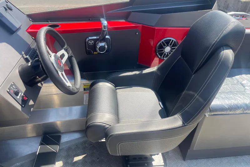Slide: The Image of 2024 Stabicraft Treker Profish cockpit with steering wheel and comfortable seating. - 15