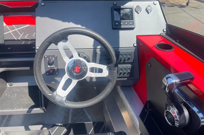 Slide: The Image of 2024 Stabicraft Treker Profish dashboard with steering wheel and control panel. - 16