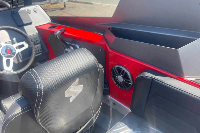 Slide: The Image of 2024 Stabicraft Treker Profish interior with red dashboard and black seating. - 6