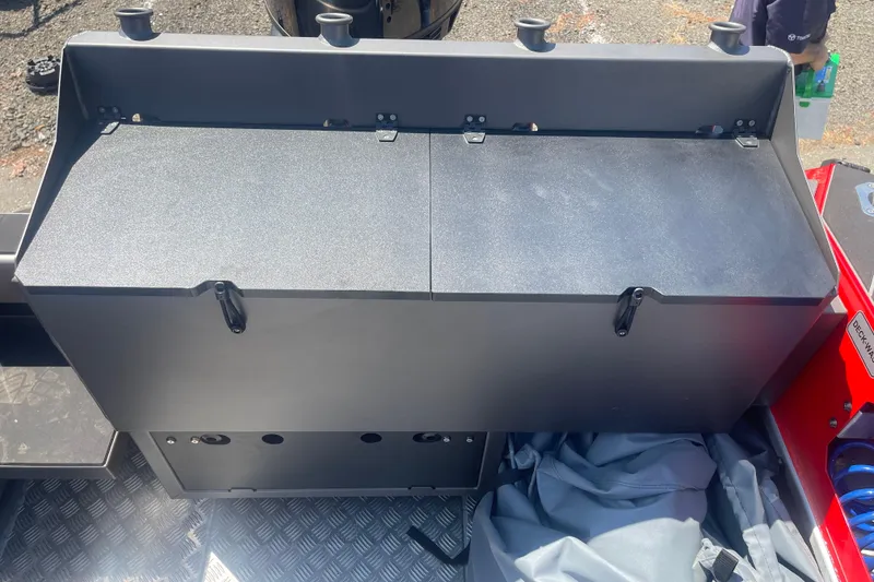 Slide: The Image of 2024 Stabicraft Treker Profish boat interior with storage compartment and rod holders. - 9