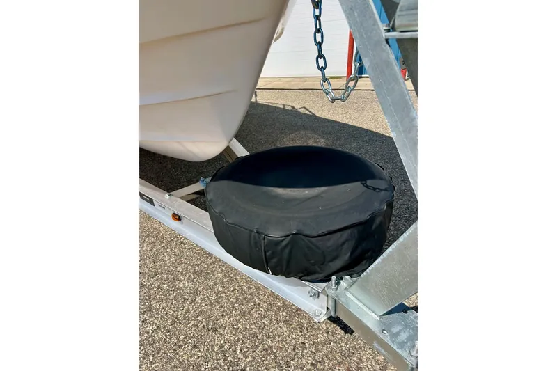 Slide: The Image of 2006 Grady White 225 Dual Console boat trailer with covered spare tire. - 10